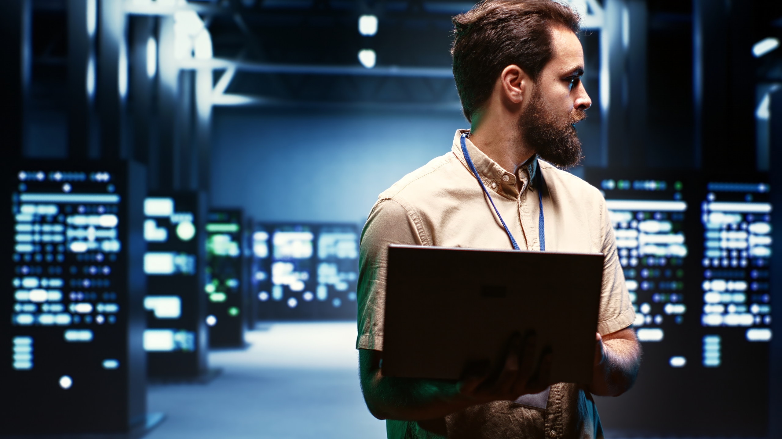 Supervisor using laptop to oversee energy consumption across server hub components and distributors. Serviceman ensuring high tech facility sensors for temperature and humidity are working properly